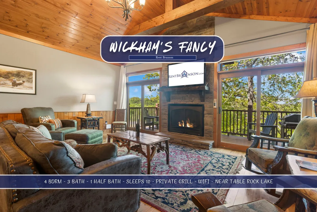 The image showcases a warm, inviting living room centered around a crackling fireplace, with plush seating arranged for comfort. Large windows frame serene wooded views, bathing the space in natural light, while the layout invites guests to gather and relax. The ambiance is perfect for family bonding, game nights, or unwinding after a day of exploring Branson.